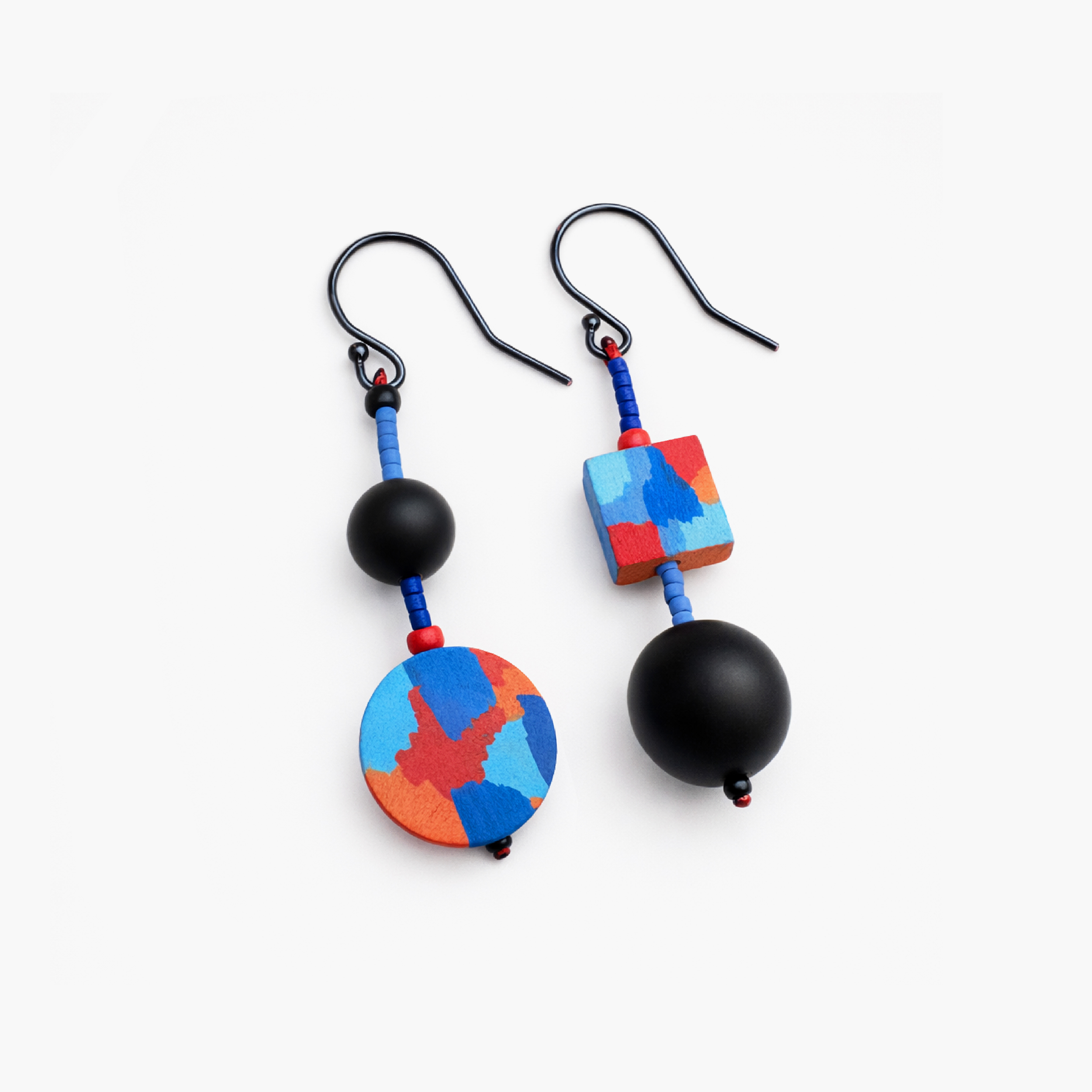 colorful geometric mismatched earrings on clean white background